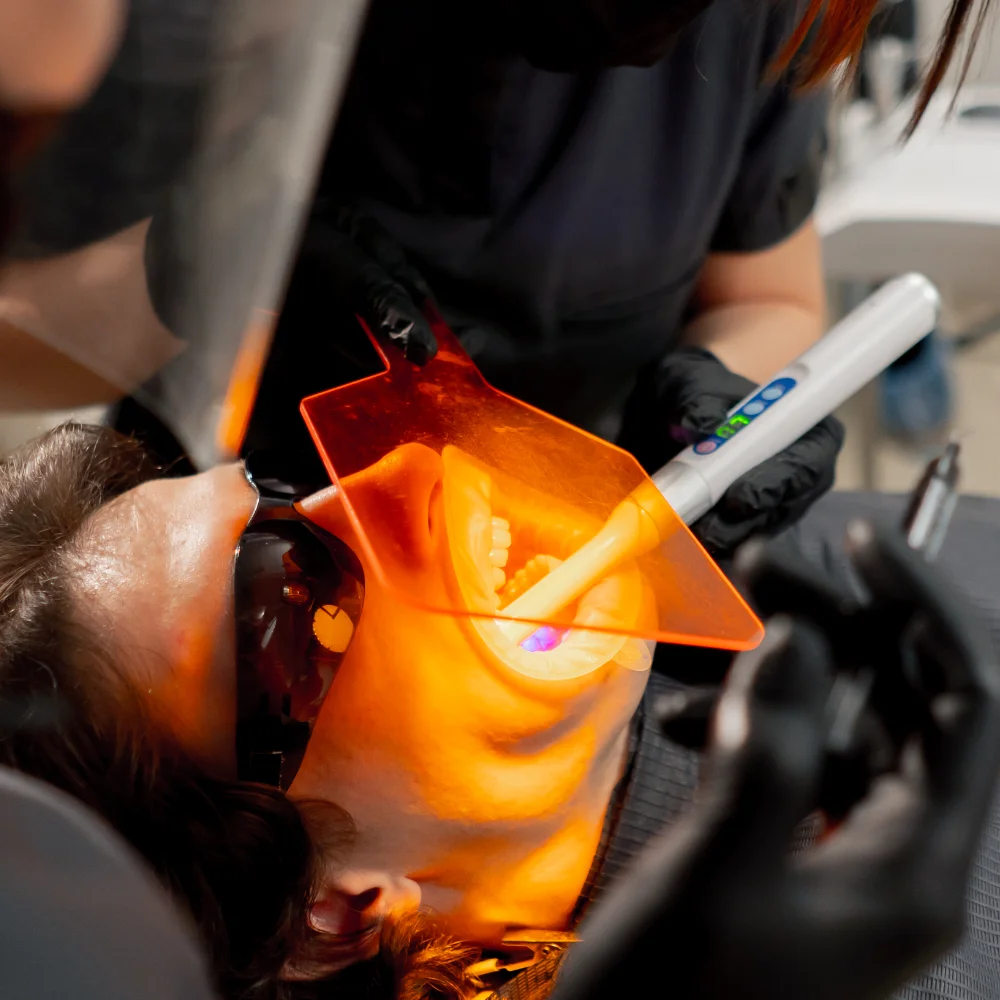 dental-office-girl-dentist-applies-protective-gel-K9L3GF9