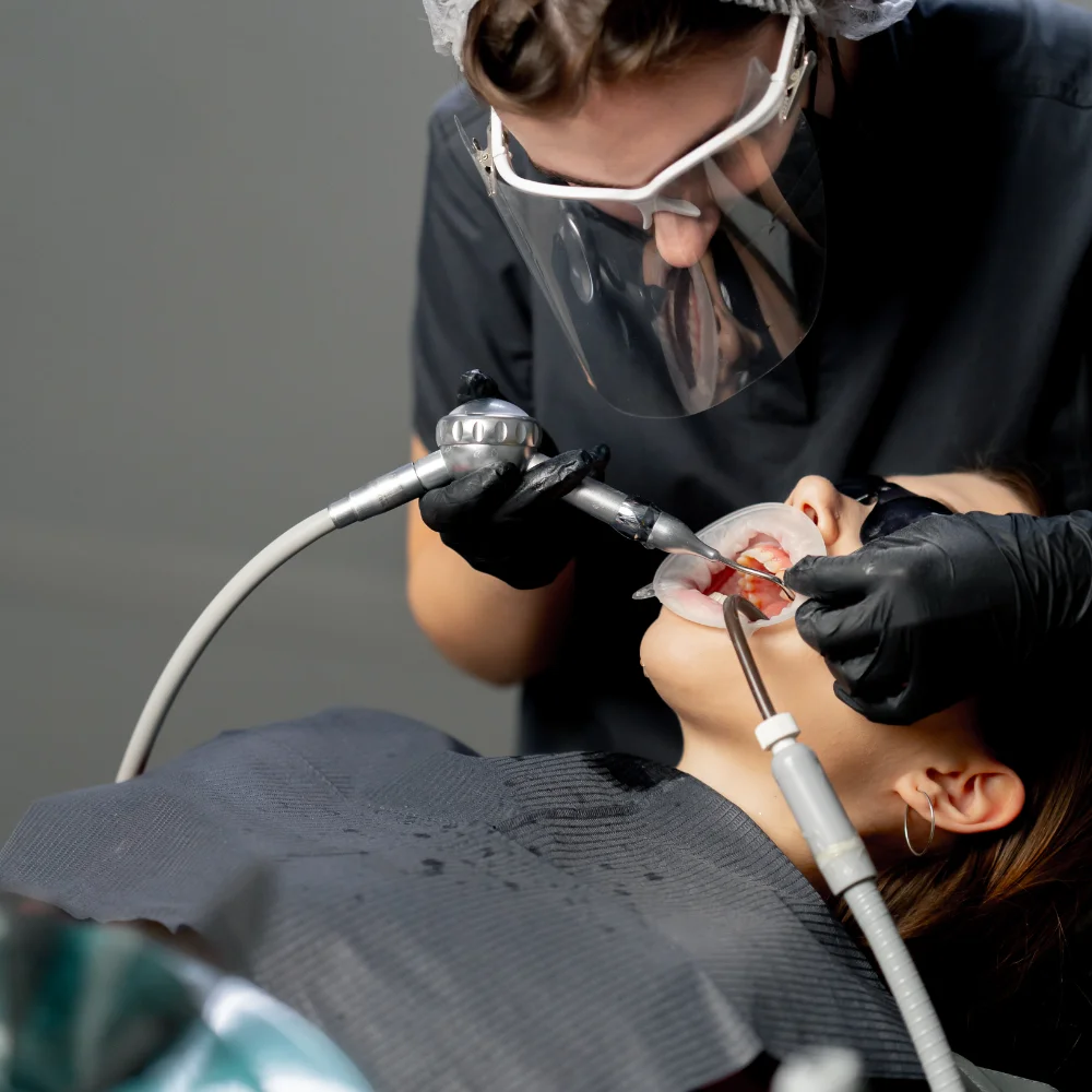 in-a-dental-office-female-dentist-in-a-cap-is-rout-RZH6MZL